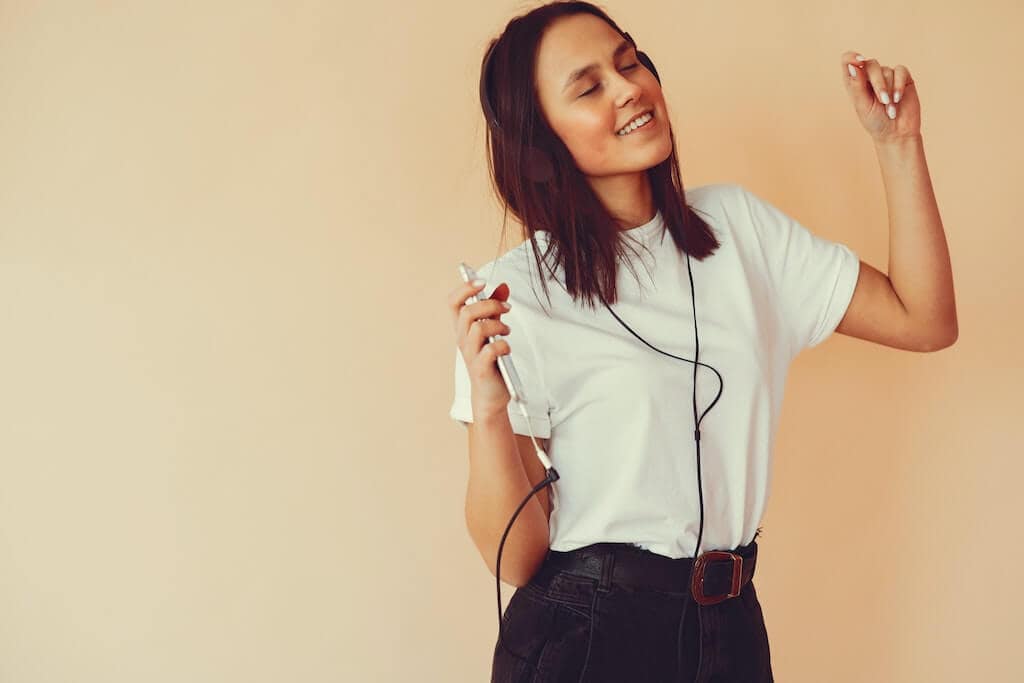 Women dancing while listening to a MP3 file on headphones