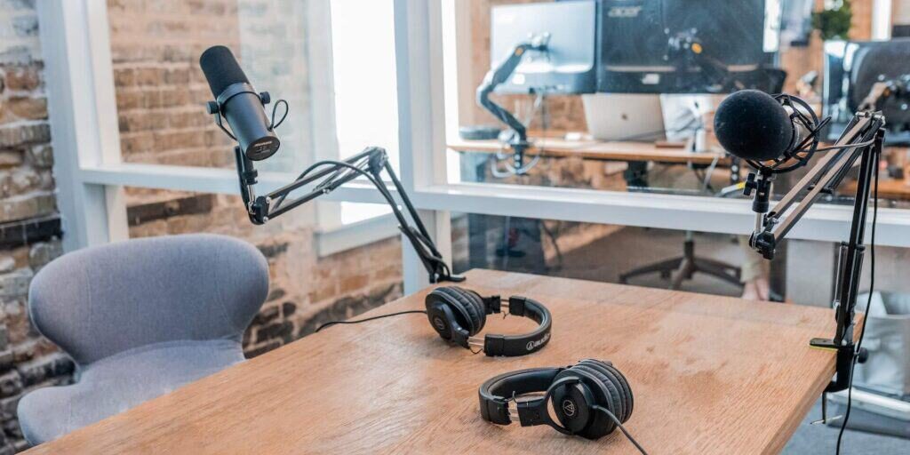 Empty podcast studio with a mic and headphones on a table