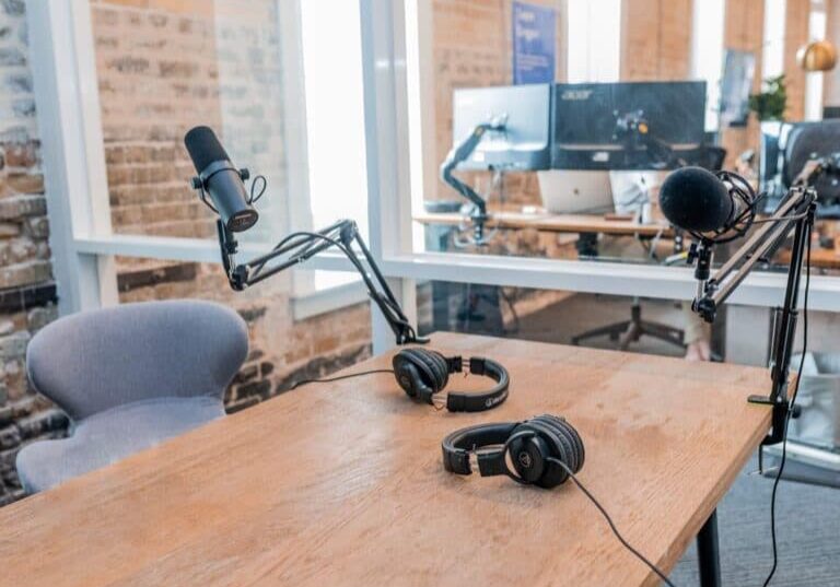 Empty podcast studio with a mic and headphones on a table